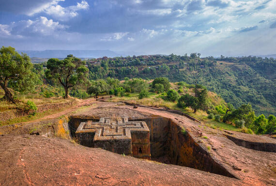 A large rock structure on top of a hill.